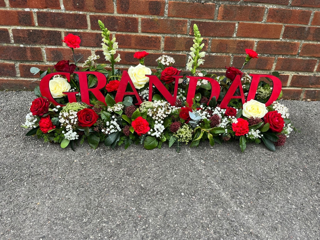 Wooden Letters in a Garden of flowers